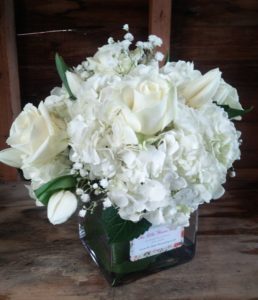 SMALL-FLORAL-ARRANGEMENT-white-hydrangea-roses-tulips-the-little-flower-shop-event-flowers-unleash-the-power-within-tony-robbins